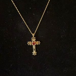 14kt gold cross with ruby center stone.